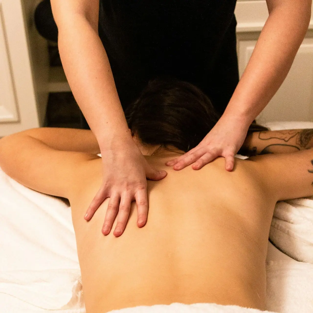 a woman getting a back massage at a spa